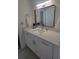 Bathroom featuring a vanity with white cabinets, white countertop and a decorative mirror at 1912 Providence Rd, Lakeland, FL 33805