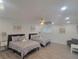 A spacious bedroom featuring two beds, a ceiling fan, and sitting area at 1912 Providence Rd, Lakeland, FL 33805