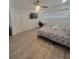 Bedroom featuring laminate floors, a closet, a desk and tv at 1912 Providence Rd, Lakeland, FL 33805