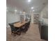 Open dining room with wood-style flooring, neutral gray accents, and a modern light fixture at 1912 Providence Rd, Lakeland, FL 33805