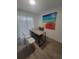 This home office has modern desk, seating, and a beach scene painting at 1912 Providence Rd, Lakeland, FL 33805