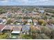 Real estate aerial view of the community showcasing tree-lined streets, houses, and nearby lake at 2448 Brownwood Dr, Mulberry, FL 33860