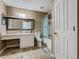 Bathroom featuring tiled floors, a white vanity with a mirror, toilet, and bathtub with sliding glass doors at 2448 Brownwood Dr, Mulberry, FL 33860