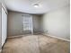 Bedroom featuring tan carpet, large closet, and natural light at 2448 Brownwood Dr, Mulberry, FL 33860