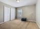 Bedroom featuring tan carpet and closet at 2448 Brownwood Dr, Mulberry, FL 33860