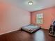 Bedroom featuring dark wood floors and a window at 2448 Brownwood Dr, Mulberry, FL 33860