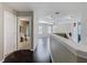 Hallway with hardwood floors that leads to bathroom and bedrooms. Natural light at 2448 Brownwood Dr, Mulberry, FL 33860