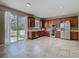 Bright kitchen featuring stainless steel appliances, wood cabinets, and a sliding glass door to backyard at 2448 Brownwood Dr, Mulberry, FL 33860