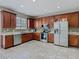 Well-lit kitchen featuring stainless steel appliances, wooden cabinetry and a tile backsplash at 2448 Brownwood Dr, Mulberry, FL 33860