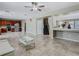 Open-concept living room featuring tile flooring, a ceiling fan, and seamless flow to the kitchen at 2448 Brownwood Dr, Mulberry, FL 33860