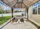 Covered outdoor dining area featuring a table with benches, offering a comfortable space for relaxation at 2448 Brownwood Dr, Mulberry, FL 33860