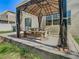 Covered outdoor dining area with a metal roof, creating a cozy and shaded space for outdoor meals at 2448 Brownwood Dr, Mulberry, FL 33860