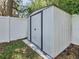 Durable metal shed with double doors, providing secure and accessible storage in the backyard at 2448 Brownwood Dr, Mulberry, FL 33860