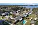 Aerial view of a neighborhood with a community lake and a home with a private backyard pool at 800 22Nd Nw St, Winter Haven, FL 33881