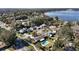 Scenic aerial view of a residential neighborhood featuring homes and a picturesque lake at 800 22Nd Nw St, Winter Haven, FL 33881