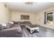 Comfortable living room featuring a gray sectional sofa, stylish flooring, and natural light at 800 22Nd Nw St, Winter Haven, FL 33881