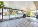 Covered patio area with tiled flooring, screen enclosure, and a view of the pool at 800 22Nd Nw St, Winter Haven, FL 33881