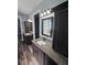 Bathroom featuring double vanity with granite counters, dark cabinets and modern fixtures at 1264 Buckeye Ne Rd, Winter Haven, FL 33881