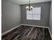 Simple dining room features wood-look flooring, natural light, and a decorative chandelier at 1264 Buckeye Ne Rd, Winter Haven, FL 33881