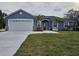 Charming single-story home boasts a well-manicured lawn and a two car garage at 1264 Buckeye Ne Rd, Winter Haven, FL 33881