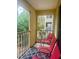 A sunny balcony has outdoor chairs and peaceful views at 101 Bent Tree Dr # 12, Daytona Beach, FL 32114