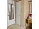 Neutral hallway with a mirror and a door leading to additional rooms or storage space at 101 Bent Tree Dr # 12, Daytona Beach, FL 32114