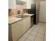 Functional kitchen featuring white cabinets, stainless steel appliances, and tile flooring at 101 Bent Tree Dr # 12, Daytona Beach, FL 32114
