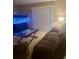 Cozy living room featuring a comfortable couch, large aquarium, and natural light at 101 Bent Tree Dr # 12, Daytona Beach, FL 32114