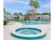 Community pool and jacuzzi surrounded by lounge chairs and tropical landscaping at 101 Bent Tree Dr # 12, Daytona Beach, FL 32114