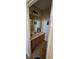Half bathroom with a tiled floor, framed mirror, vanity, and framed artwork on the walls at 315 Villa Sorrento Cir, Haines City, FL 33844