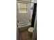 Bathroom with a shower-tub, a tile surround, and a tiled floor at 315 Villa Sorrento Cir, Haines City, FL 33844
