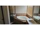Elegant bathroom features a bathtub with a separate glass door shower at 315 Villa Sorrento Cir, Haines City, FL 33844
