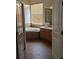 Bathroom featuring a bathtub, vanity, tile floors, and bright natural light from the window at 315 Villa Sorrento Cir, Haines City, FL 33844