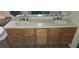 Bathroom vanity with dual sinks, quartz countertop, and wood cabinetry at 315 Villa Sorrento Cir, Haines City, FL 33844