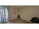 Bedroom featuring sliding glass door with blinds, window, and tan carpet at 315 Villa Sorrento Cir, Haines City, FL 33844