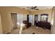 Cozy bedroom with a closet, ceiling fan, an armchair, and a dresser with a mirror at 315 Villa Sorrento Cir, Haines City, FL 33844