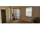 Bedroom featuring sliding glass door with blinds, window, and tan carpet at 315 Villa Sorrento Cir, Haines City, FL 33844
