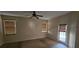 Bedroom with carpeted floors, ceiling fan, two windows, and access to an outdoor patio at 315 Villa Sorrento Cir, Haines City, FL 33844