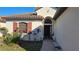 Inviting front entrance with arched doorway, red-tiled roof and beautiful landscaping at 315 Villa Sorrento Cir, Haines City, FL 33844