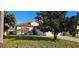 Charming single Gathering home featuring a beautifully landscaped front yard with a lovely Magnolia tree at 315 Villa Sorrento Cir, Haines City, FL 33844
