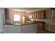 Open kitchen features wood cabinetry, matching appliances, and a breakfast bar for casual dining at 315 Villa Sorrento Cir, Haines City, FL 33844