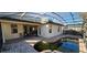 Screened-in pool area featuring a brick-lined pool, patio, and ample space for outdoor lounging and entertaining at 315 Villa Sorrento Cir, Haines City, FL 33844