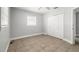 Bright bedroom features tile flooring, closet space, and natural light at 725 Strain Blvd, Lakeland, FL 33815