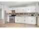 Well-lit kitchen features white cabinetry, tile flooring, and stainless-steel appliances at 725 Strain Blvd, Lakeland, FL 33815