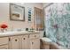 Bathroom featuring white vanity, decorative mirror, and floral shower curtain at 1176 Balfour Dr, Deltona, FL 32725