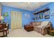 Bedroom featuring blue walls, a tan sofa with ottoman, and a closet with folding doors at 1176 Balfour Dr, Deltona, FL 32725