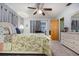 Well-lit bedroom with floral bedding and access to an outdoor patio offers a cozy and convenient living space at 1176 Balfour Dr, Deltona, FL 32725