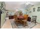 Open dining area with a wooden table, eight chairs, decorative wall art, and bright lighting at 1176 Balfour Dr, Deltona, FL 32725