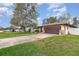 One-story home with a two-car garage, front lawn, and brick accents on a sunny day in a quiet neighborhood at 1176 Balfour Dr, Deltona, FL 32725