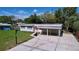 Aerial view of the house highlighting its landscaping, carport, and surrounding neighborhood at 1625 Avenue D Ne, Winter Haven, FL 33881